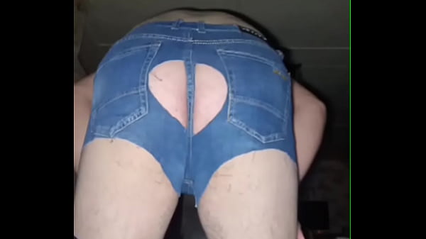 A fat-assed gay man masturbates his cock in ripped denim shorts and black stockings!